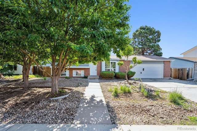 9222 Albion St, Thornton, CO 80229 - view of front of house with brick siding, an attached garage, and concrete driveway