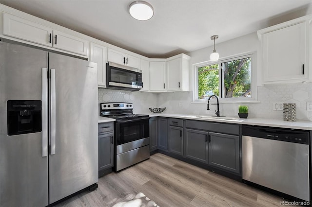 9222 Albion St, Thornton, CO 80229 - kitchen with stainless steel appliances, gray cabinets, light countertops, and white cabinets