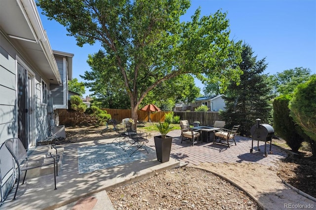 9222 Albion St, Thornton, CO 80229 - fenced backyard featuring a fire pit, a grill, and a patio