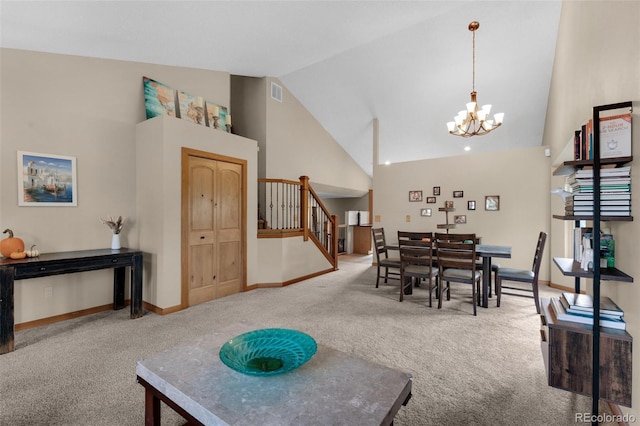 dining area featuring carpet, a notable chandelier, and high vaulted ceiling