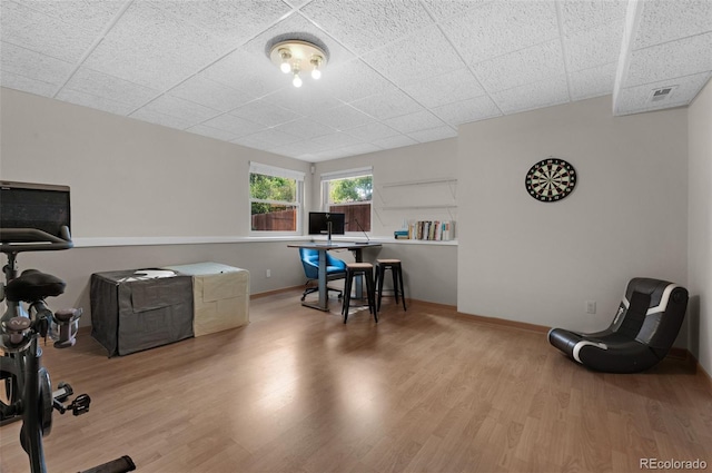 office space featuring hardwood / wood-style floors and a paneled ceiling