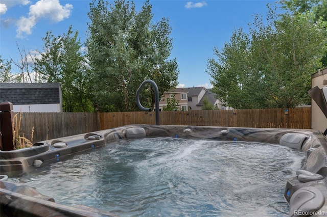 view of pool with a hot tub