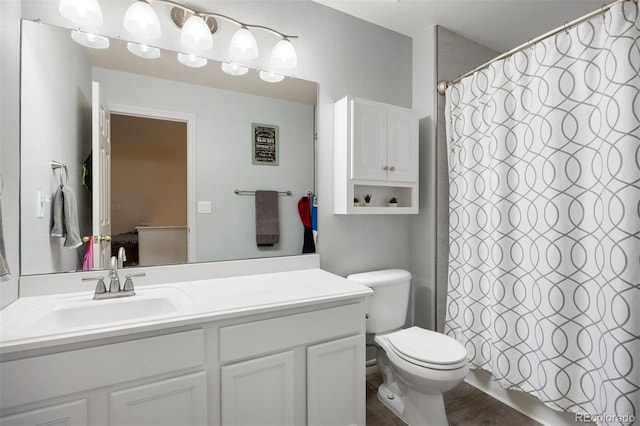 6471 S Ider St, Aurora, CO 80016 - full bathroom with vanity, a shower with curtain, and wood finished floors