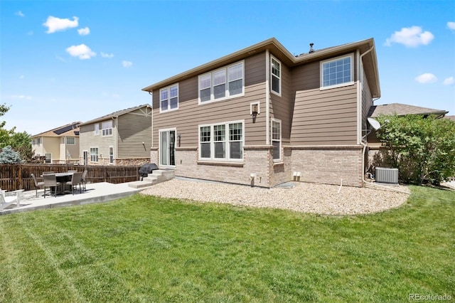 6471 S Ider St, Aurora, CO 80016 - rear view of property featuring brick siding and a patio area