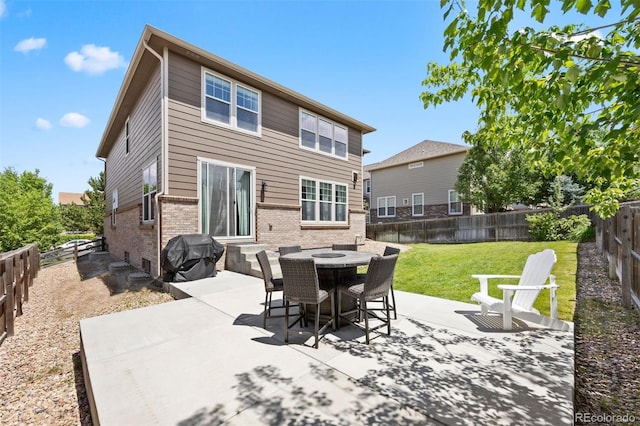 6471 S Ider St, Aurora, CO 80016 - back of property with brick siding, a patio, a fenced backyard, and entry steps