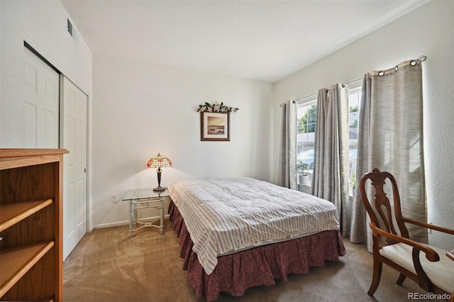 bedroom with carpet flooring and baseboards