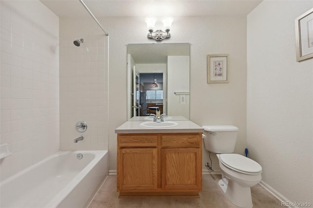 bathroom featuring shower / bathtub combination, toilet, vanity, tile patterned floors, and baseboards
