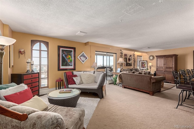 living room featuring light colored carpet and a textured ceiling