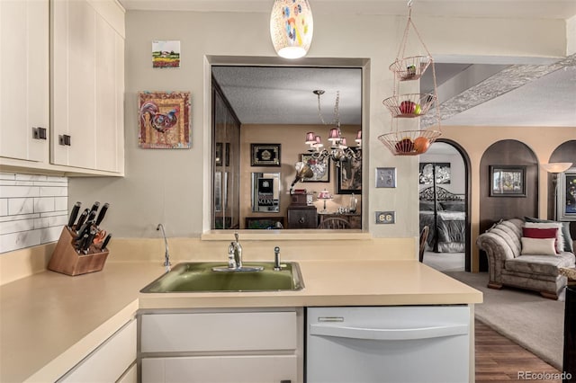 kitchen with white cabinets, tasteful backsplash, sink, dark hardwood / wood-style floors, and white dishwasher