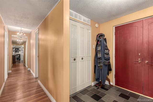 entrance foyer with a textured ceiling and an inviting chandelier