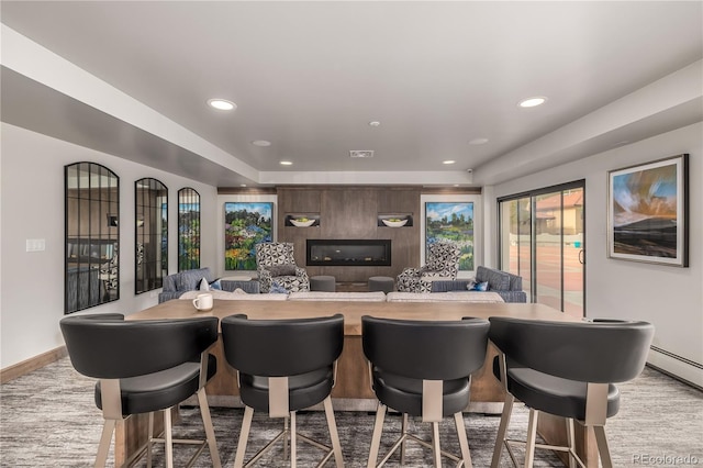 kitchen featuring a kitchen breakfast bar and baseboard heating