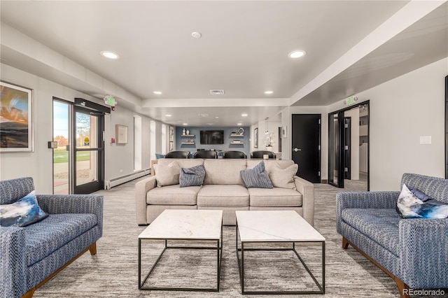 carpeted living room featuring a baseboard radiator