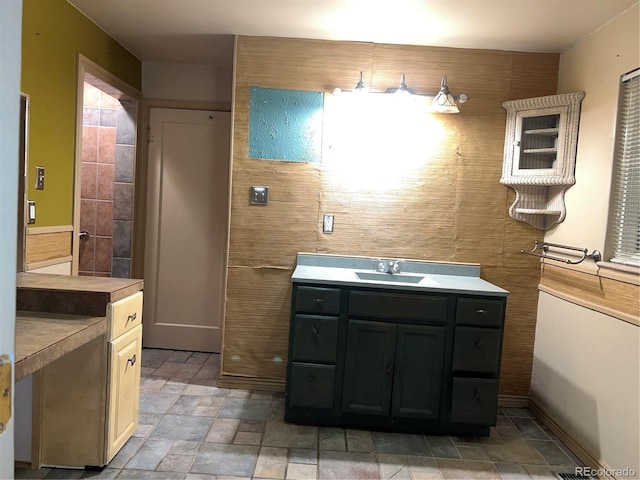 527 S Bryant St, Denver, CO 80219 - bathroom featuring stone finish floors and vanity