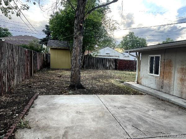 527 S Bryant St, Denver, CO 80219 - fenced backyard with a patio and an outbuilding