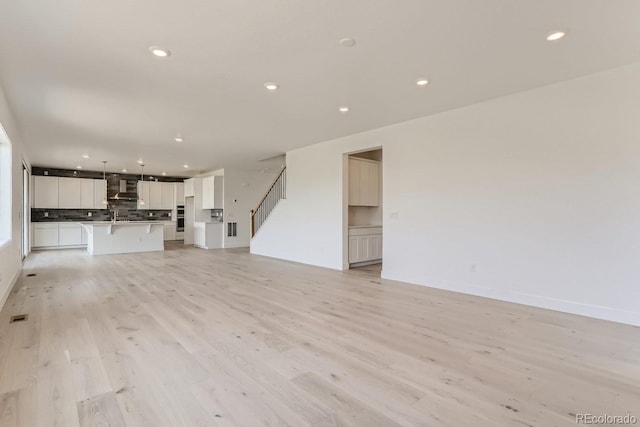 unfurnished living room with light wood-type flooring