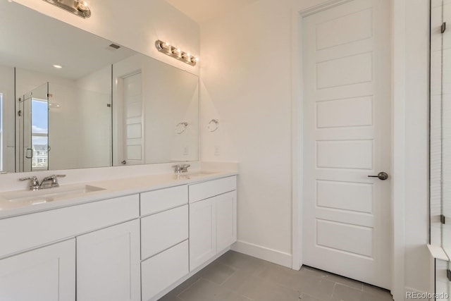 bathroom featuring tile patterned flooring, vanity, and a shower with door