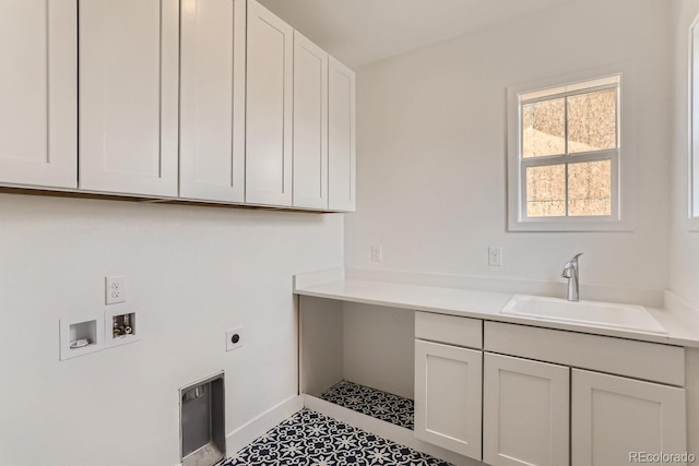 laundry room featuring electric dryer hookup, a sink, cabinet space, baseboards, and hookup for a washing machine