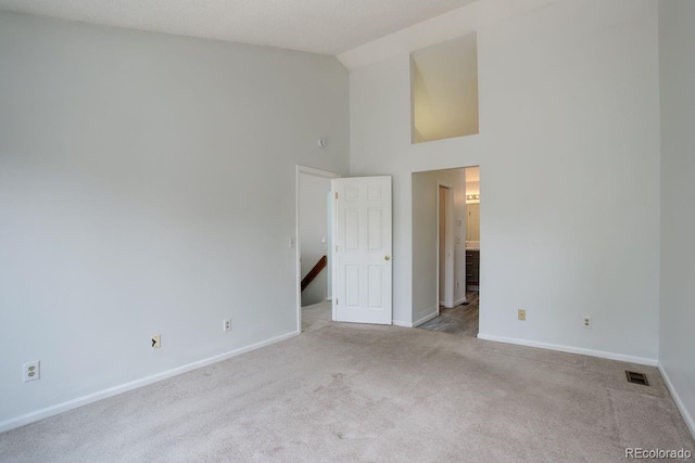 11186 E Baltic Dr, Aurora, CO 80014 - carpeted empty room with high vaulted ceiling and baseboards