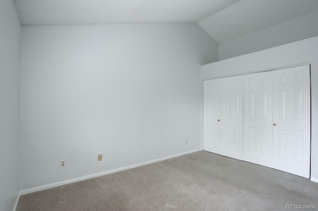 11186 E Baltic Dr, Aurora, CO 80014 - unfurnished bedroom featuring carpet, baseboards, lofted ceiling, and a closet