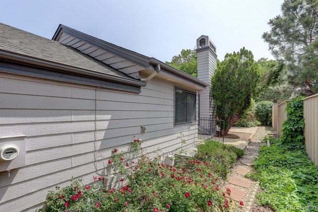 11186 E Baltic Dr, Aurora, CO 80014 - view of side of home with a chimney and roof with shingles
