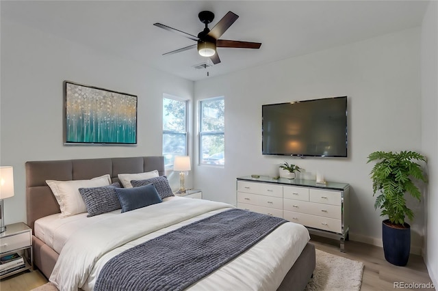 bedroom with ceiling fan and light hardwood / wood-style flooring