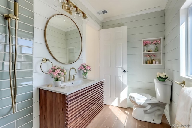 bathroom featuring vanity, toilet, and crown molding