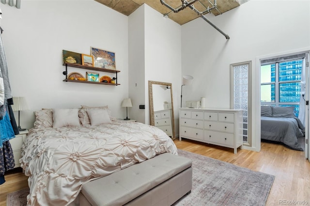 2020 Arapahoe St Unit 1250, Denver, CO 80205 - bedroom with light wood-type flooring and a towering ceiling
