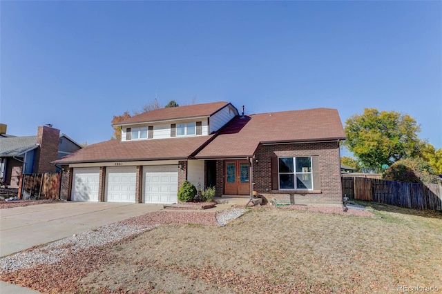 view of front of property with a garage and a front yard