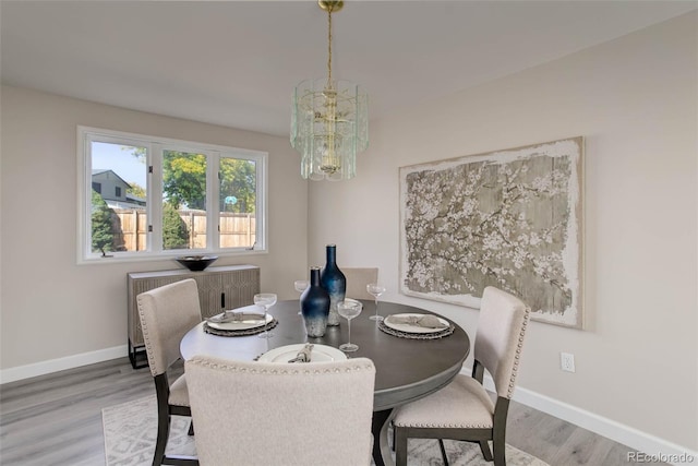 dining area with a notable chandelier, wood-type flooring, and radiator