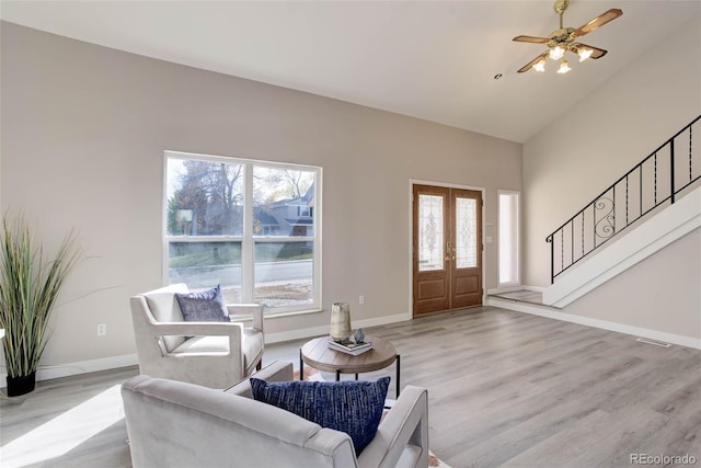 living room with french doors, light wood-type flooring, a wealth of natural light, and ceiling fan