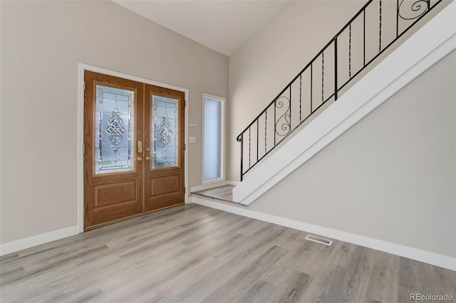 entryway with light hardwood / wood-style flooring and french doors