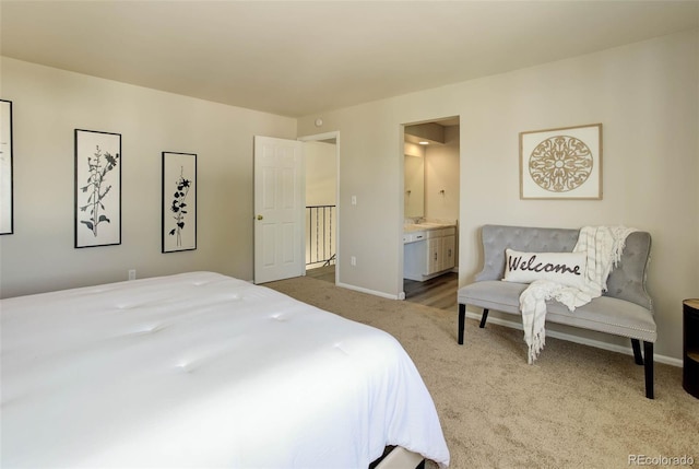 bedroom with connected bathroom and light colored carpet