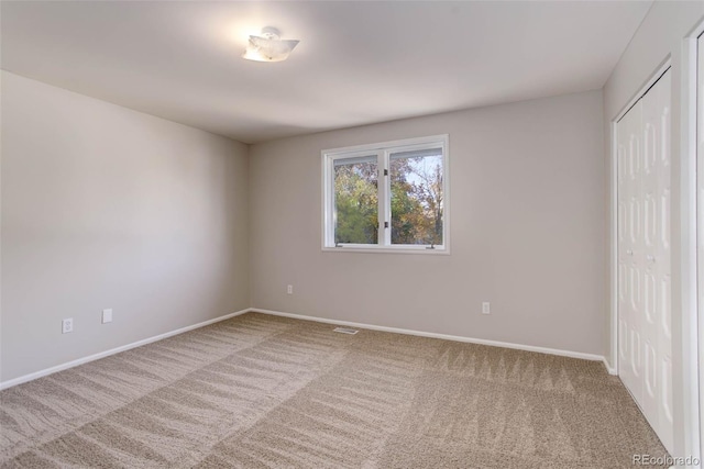 unfurnished bedroom featuring a closet and carpet floors