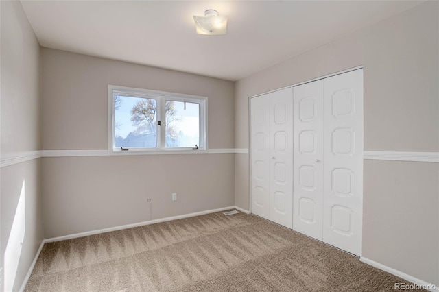 unfurnished bedroom with carpet and a closet