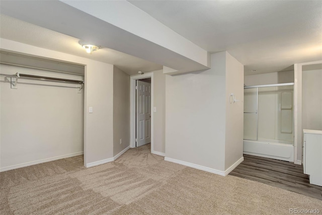 unfurnished bedroom featuring carpet flooring and a closet