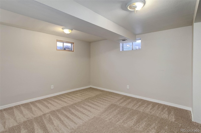 basement with a wealth of natural light and carpet