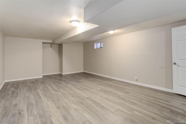 basement featuring light wood-type flooring