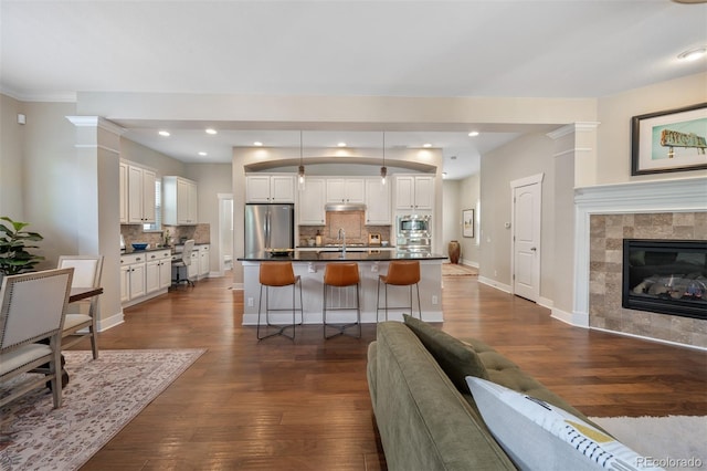 817 Uinta Way, Denver, CO 80230 - living room featuring dark wood-style floors, baseboards, recessed lighting, and a tile fireplace