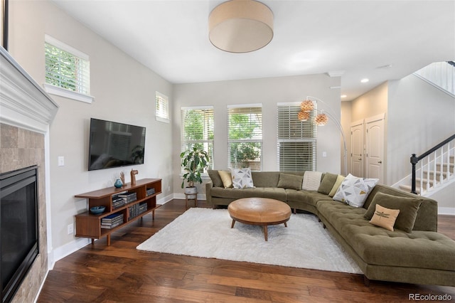 817 Uinta Way, Denver, CO 80230 - living area featuring a tiled fireplace, stairs, wood finished floors, baseboards, and recessed lighting