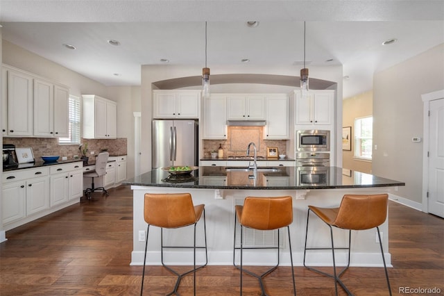 817 Uinta Way, Denver, CO 80230 - kitchen with stainless steel appliances, a sink, dark wood finished floors, decorative backsplash, and recessed lighting
