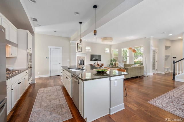 817 Uinta Way, Denver, CO 80230 - kitchen featuring open floor plan, a sink, dark wood-style flooring, white cabinets, and recessed lighting