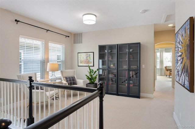 817 Uinta Way, Denver, CO 80230 - hallway featuring carpet flooring, arched walkways, healthy amount of natural light, and baseboards