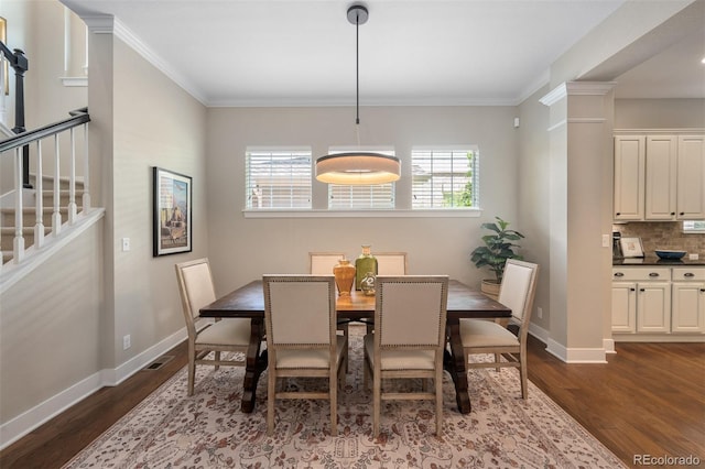817 Uinta Way, Denver, CO 80230 - dining room with dark wood-type flooring, stairs, and crown molding
