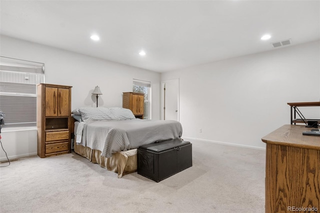 bedroom featuring light carpet, baseboards, and recessed lighting