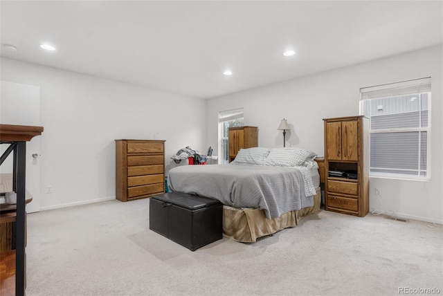bedroom featuring light colored carpet, recessed lighting, and baseboards
