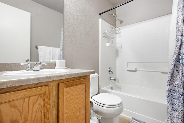 bathroom featuring toilet, shower / tub combo with curtain, vanity, and a textured wall