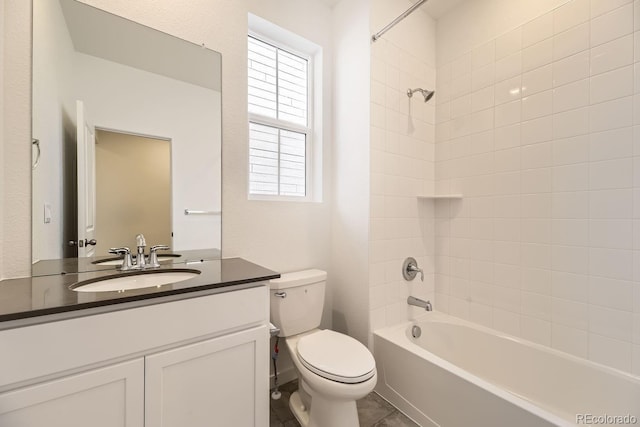 full bathroom featuring vanity, tiled shower / bath combo, and toilet