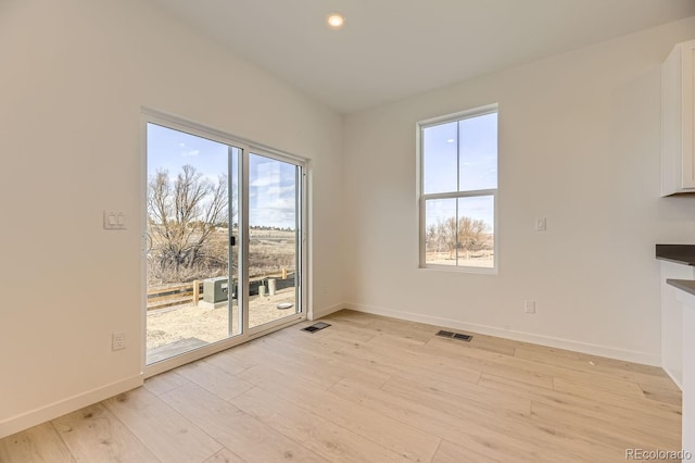 unfurnished dining area with light hardwood / wood-style flooring