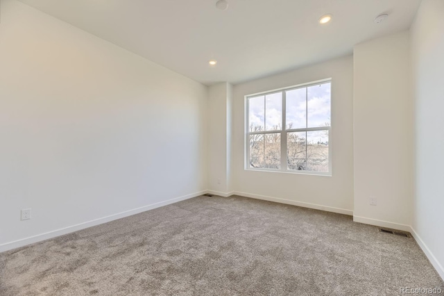 unfurnished room with light carpet