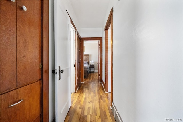hall featuring light wood-style floors and visible vents
